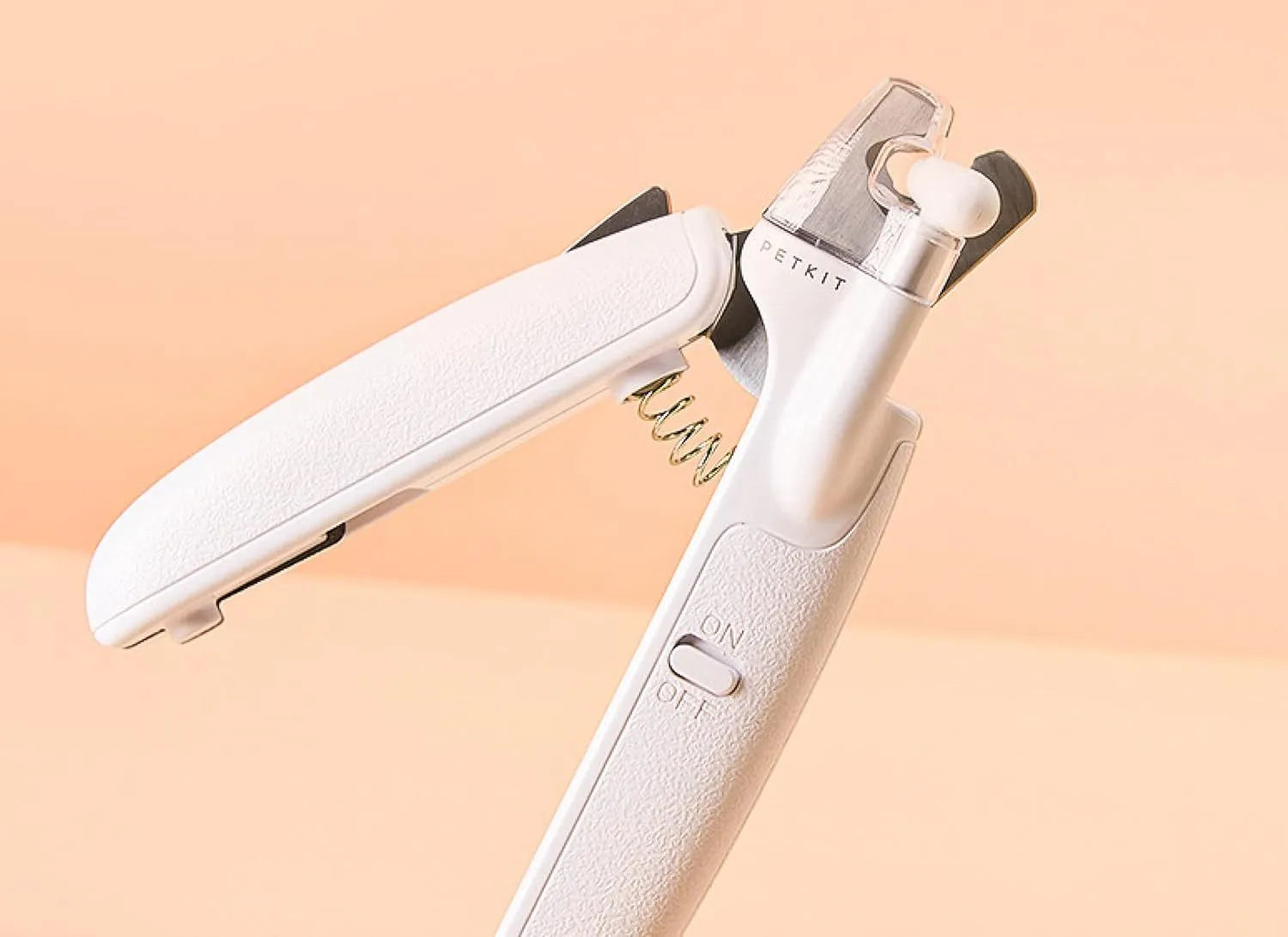 White pet nail clippers with LED light, transparent anti-splash guard and triangular blade for dogs and cats