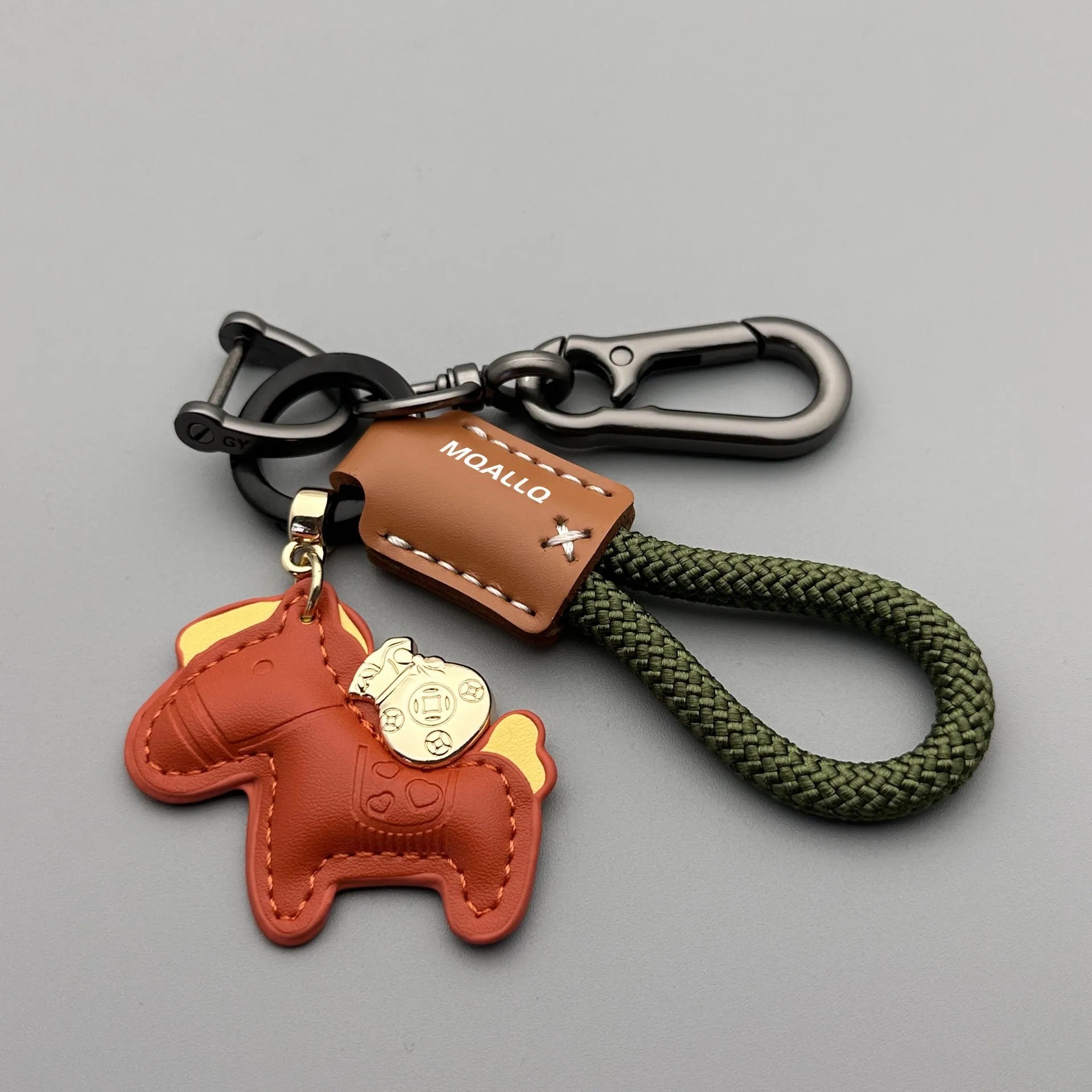 Handmade brown cowhide leather car key ring pendant with a zinc alloy belt buckle and green flanelle rope.