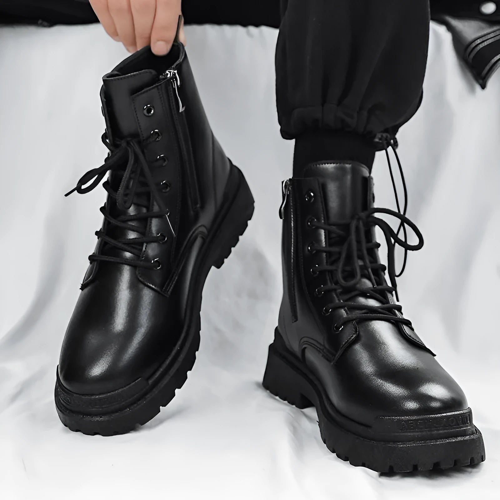 Men's black mid-top waterproof Martin boots with a rubber sole on a white background.