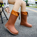 Women's PVC rain boots in solid colours with non-slip soles and waterproof mouth design