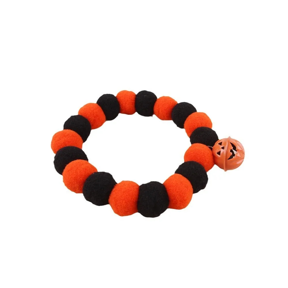 Orange and black Halloween pumpkin pet collar with jingle bell and buckle fastener for cats and dogs