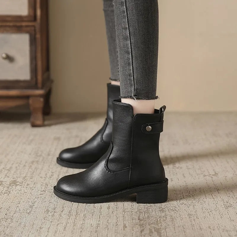 Black women's short boots with a low round toe and side zip, shown on a white background.