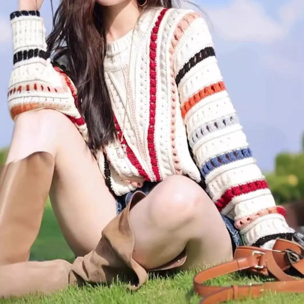 Colourful rainbow striped loose knit sweater with batwing sleeves and a round neck.