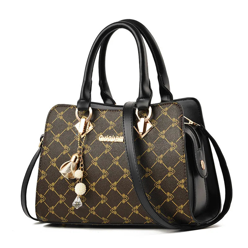 Women's geometric print PU leather messenger bag with internal organisers and zip closure.