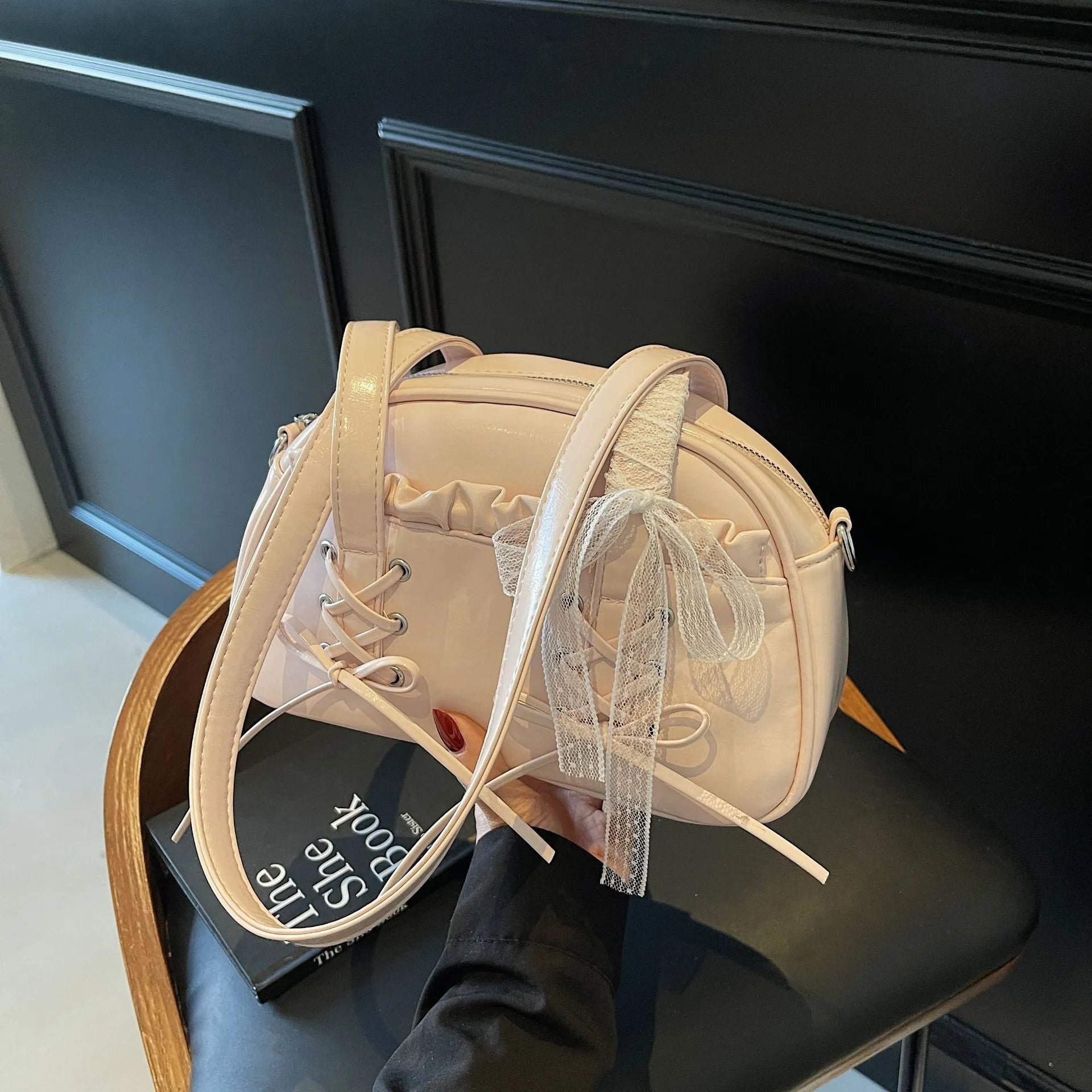 Milky white women's PU shoulder bag with a black bandage bow and sewing thread detail.