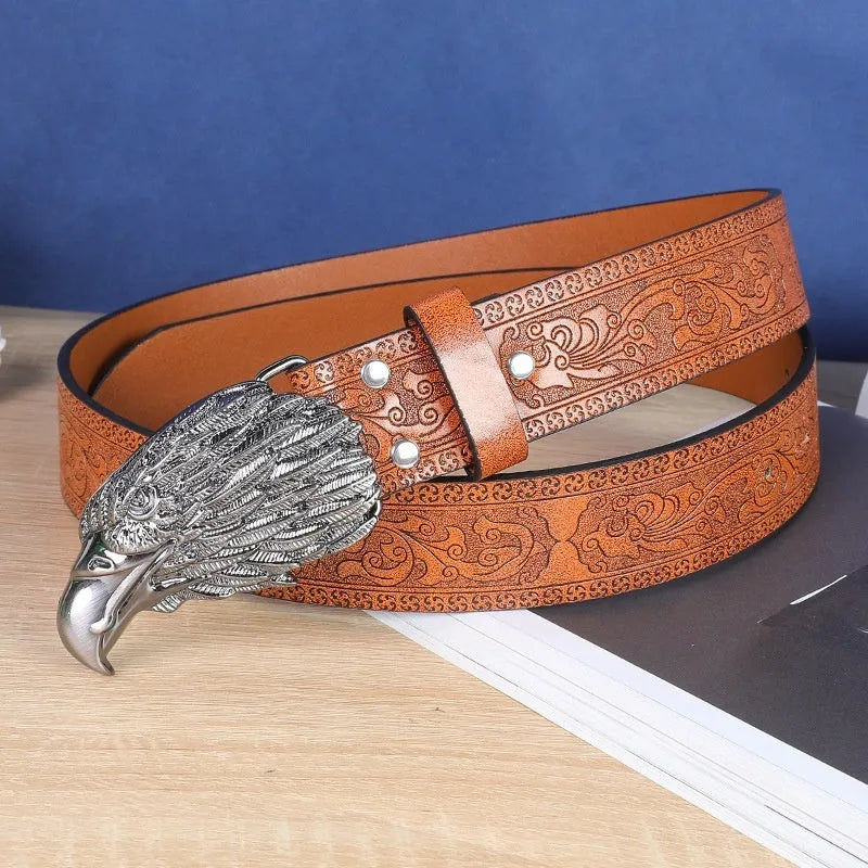 Men's brown leather-look belt with a detailed metal cow head buckle showing carved and embossed details.