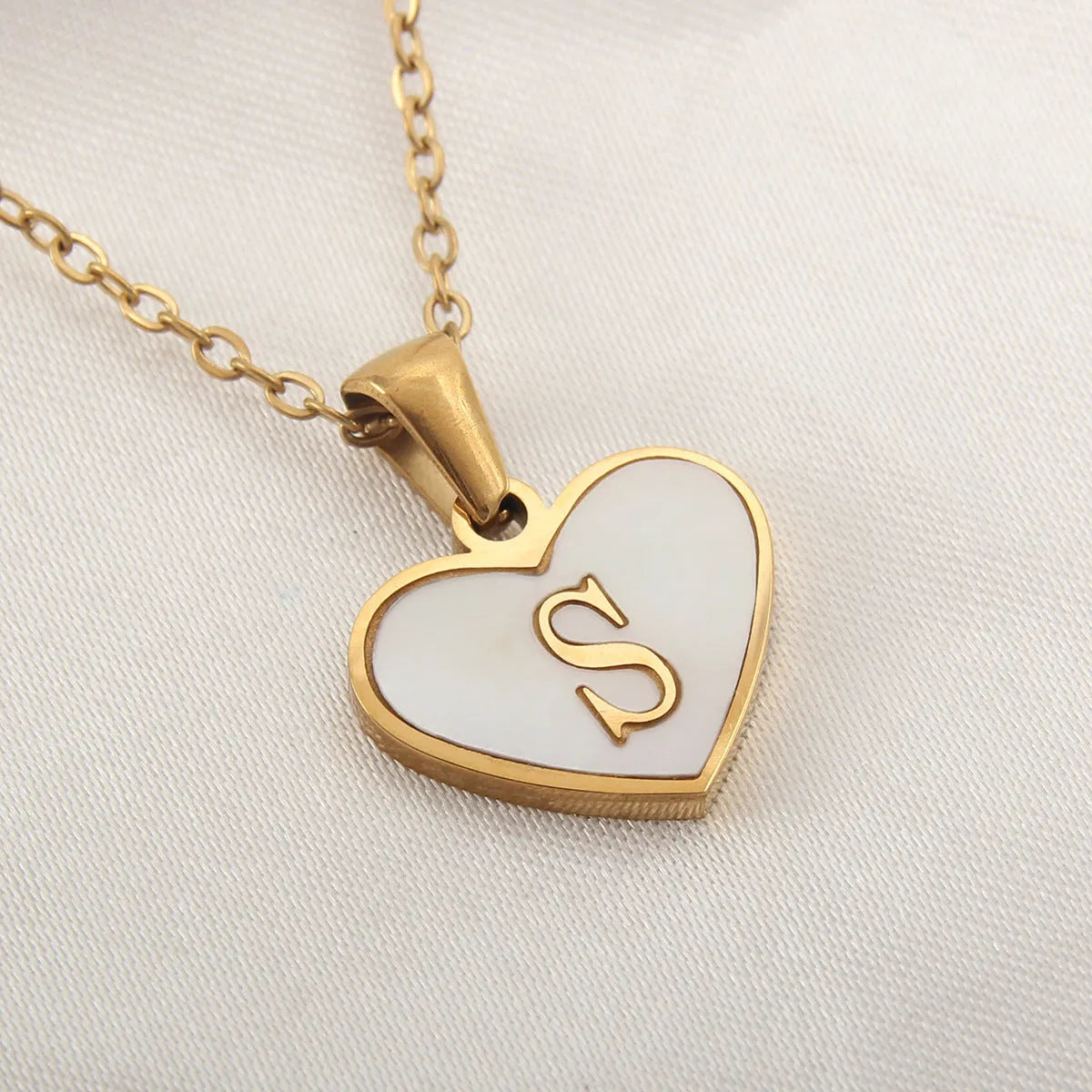 Gold plated heart-shaped personalised necklace with white shell charm on an adjustable chain.