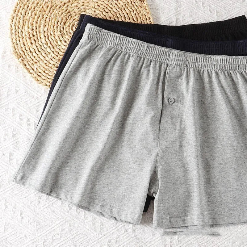 Men's solid-colour pure cotton boxer shorts with a high-waist and loose fit on a plain background.
