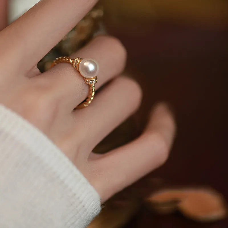 Geometric copper ring with antique twist design and pearl inlay, adjustable sizing shown