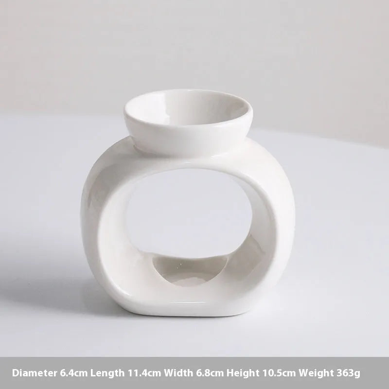 White Nordic style ceramic aromatherapy stove ornament on a table.