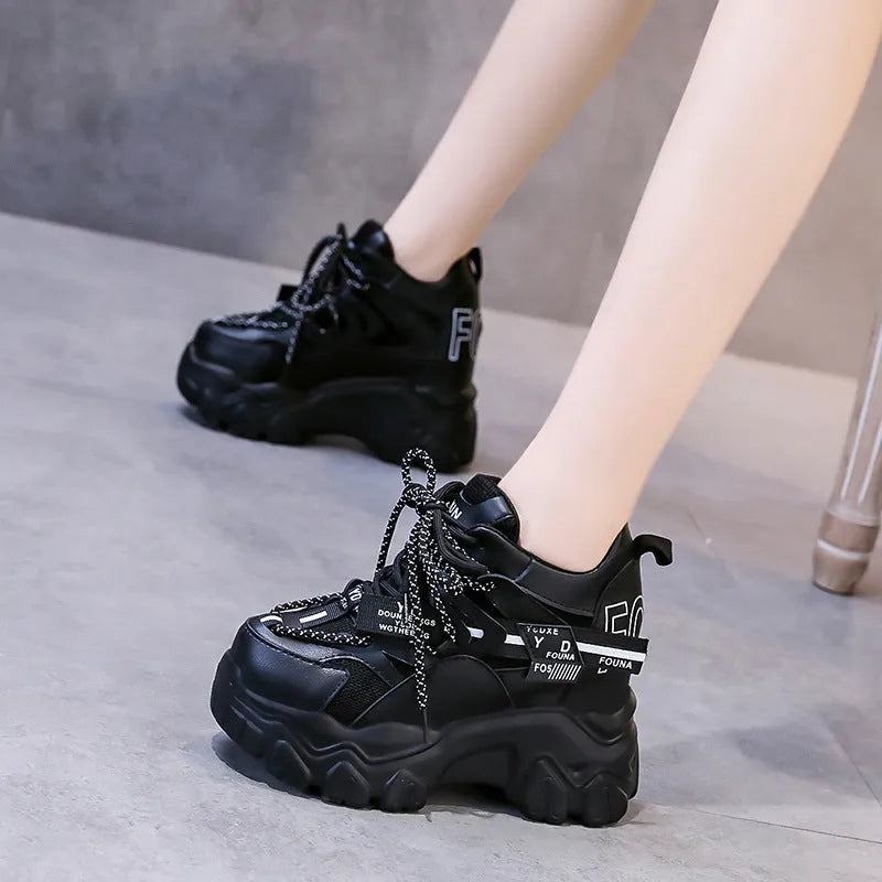 White women's mesh platform tennis shoes with cross strap and a thick rubber sole.