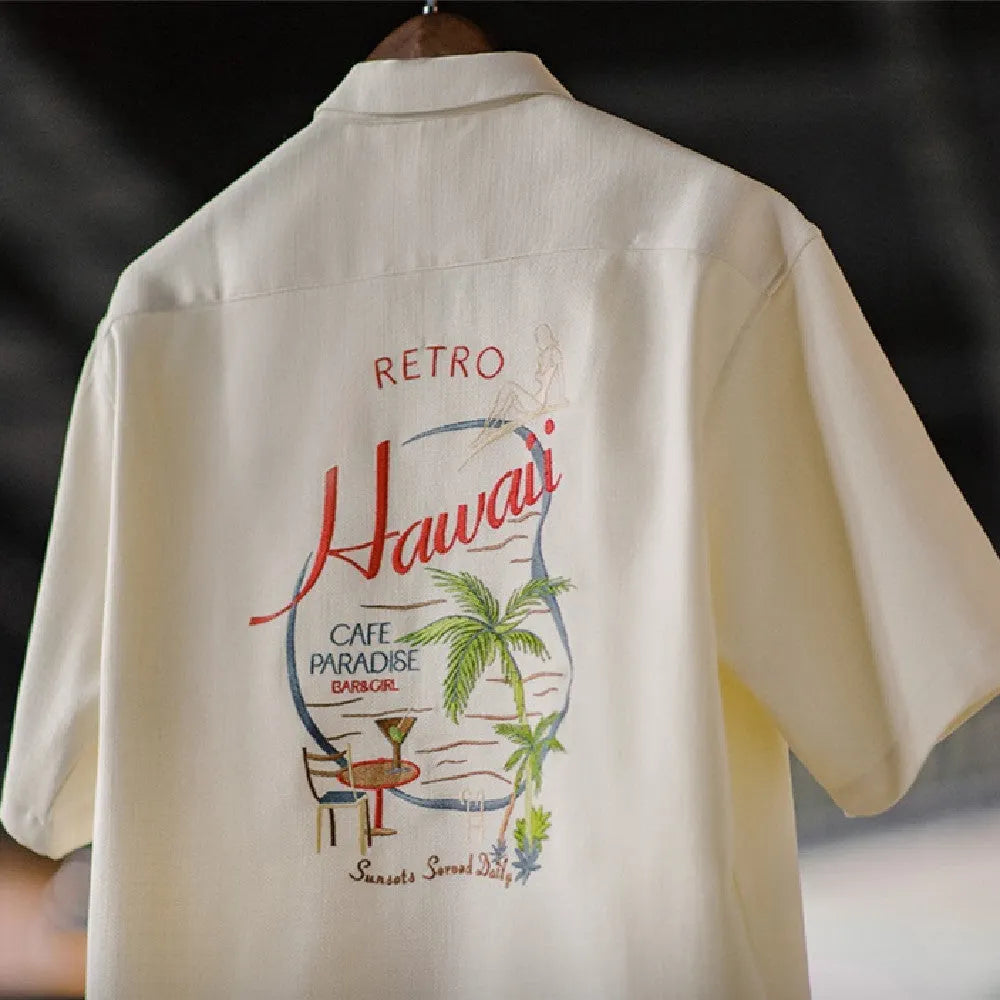 Light apricot men's shirt with a bamboo and floral pattern and a Cuban collar.