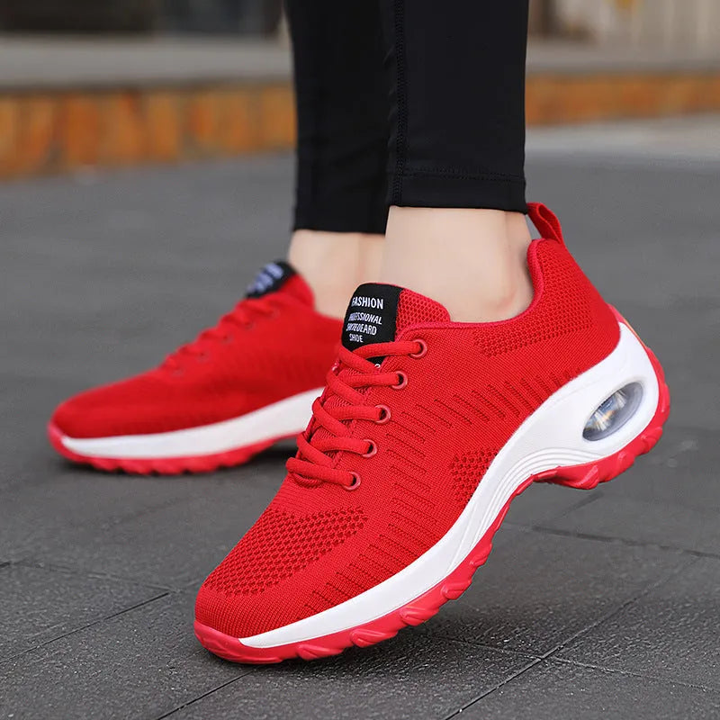Women's black mesh sneakers with round toe and front lace-up closure showing flat heel design