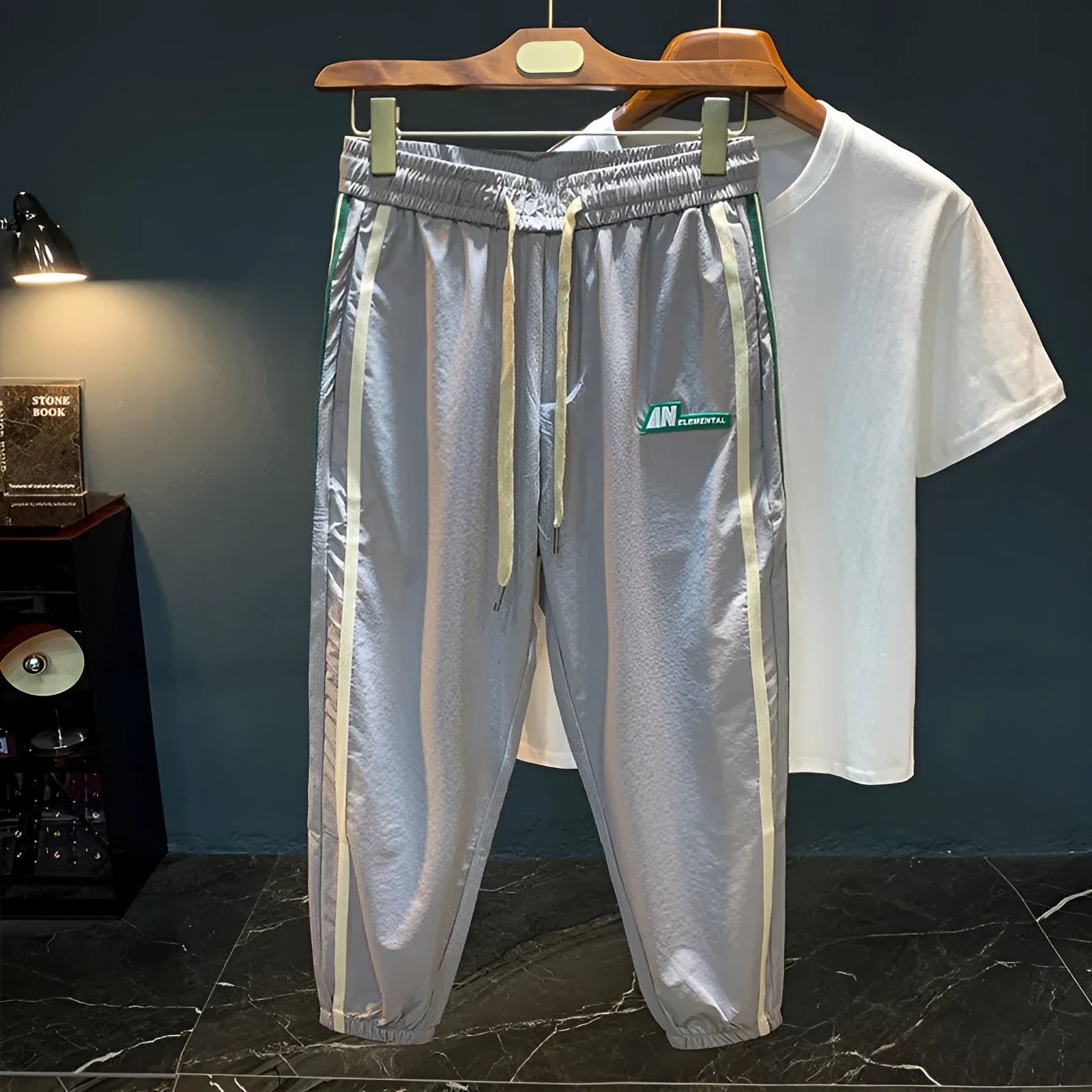 A man wearing grey cotton harem pants with a relaxed fit and elasticated mid-waist.