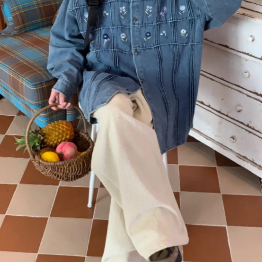 Vintage washed blue denim long sleeve shirt with small floral print and pleated details.