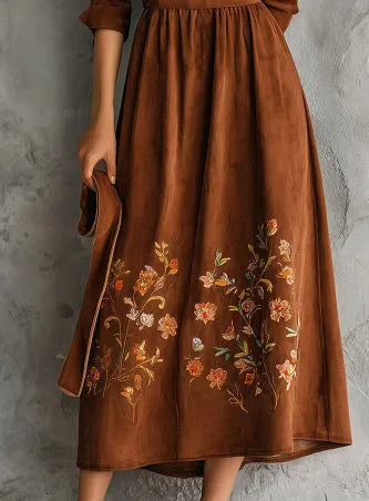 Brown knee-length vintage dress with floral embroidery on suede-like material.
