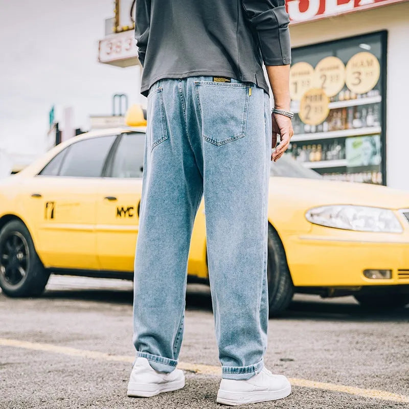 Men's loose straight cotton jeans in dark blue, light blue, and grey colours with mid-rise waist