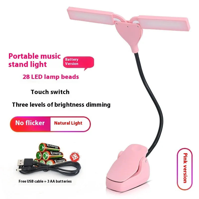 Rechargeable black music stand light with 28 lamps and USB cable on a music stand.