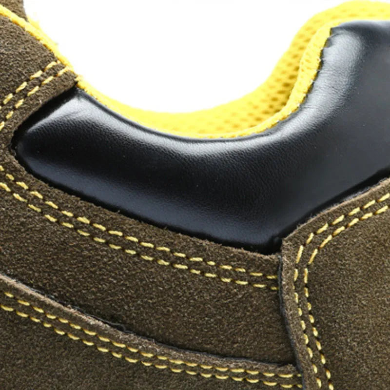 Bronze cow suede leather steel toe safety boots with non-slip sole on workplace surface