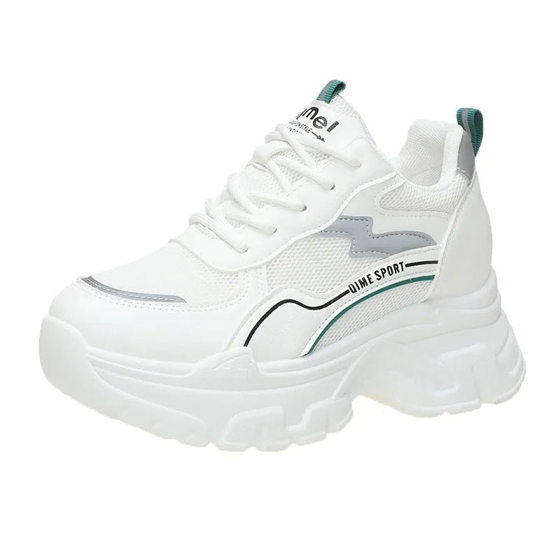 White women's low-top dad shoes with cross straps and lace-up front, showing round toe and rubber sole.