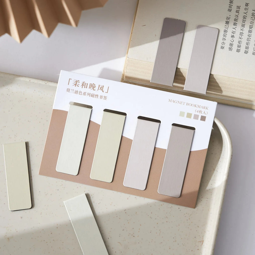 Set of four Morandi Series colour block magnetic bookmarks in pastel shades on a book page.