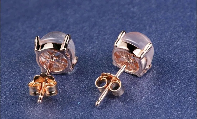 Rose gold coloured drop shape stud earrings with crystal inlay on silver base.