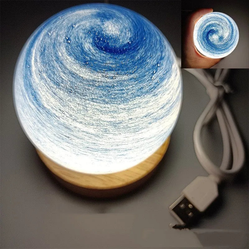 Compact modern planet USB night light on its base with dimmable three-colour lighting.