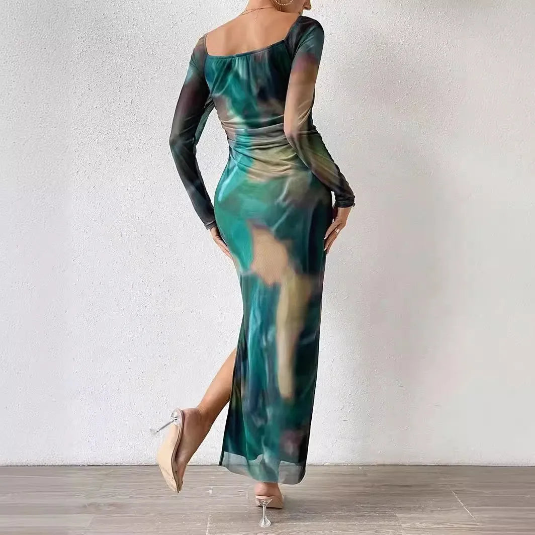 Long green mesh fishtail evening dress with a square collar, pleats, and a side split.
