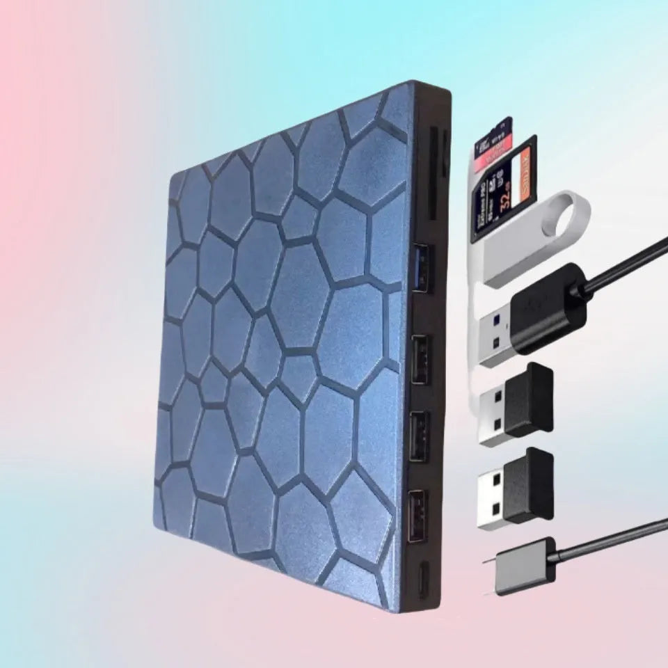 Black external USB CD/DVD writer and reader drive on a desk next to a laptop.