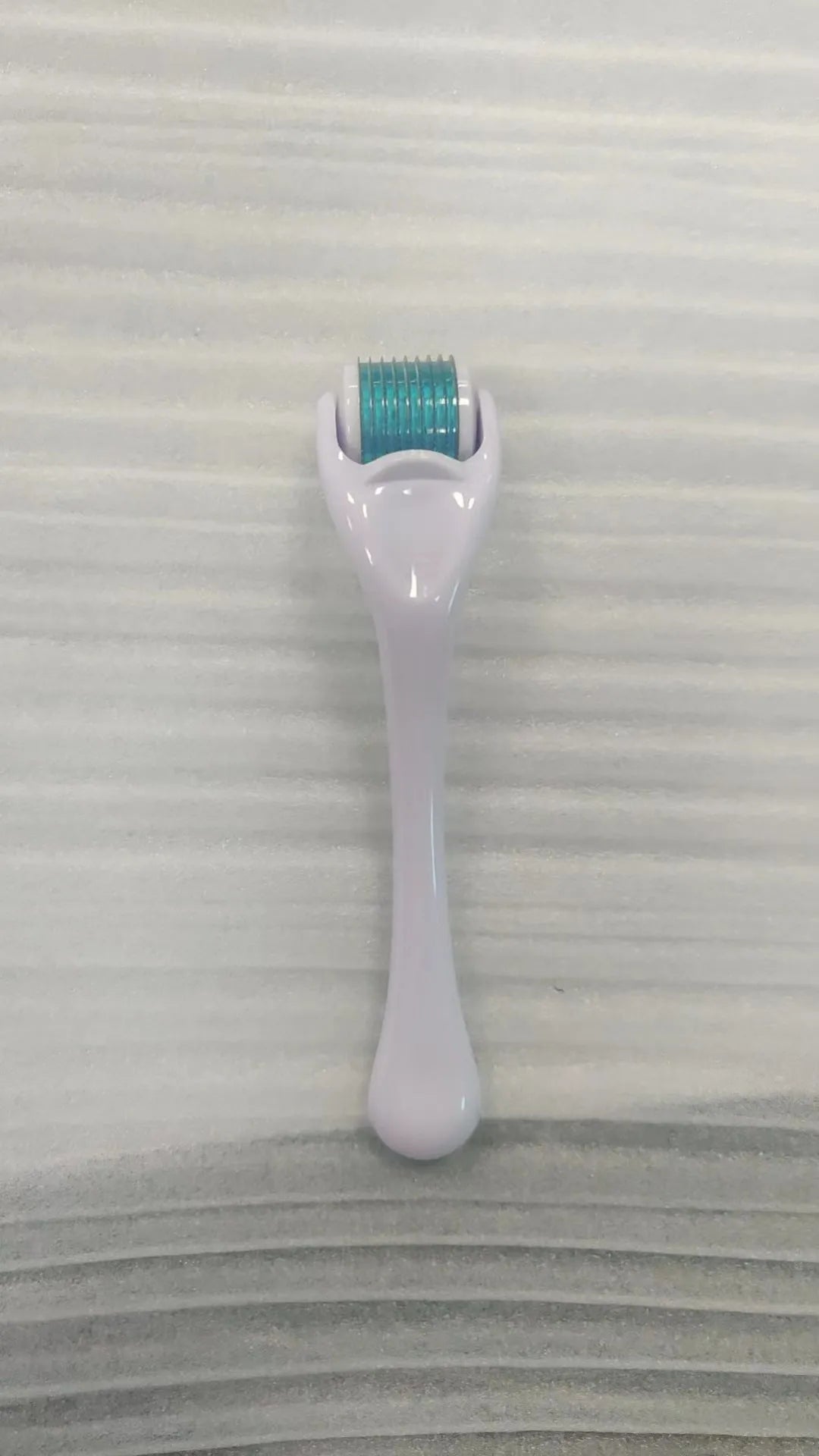 Black handle micro needle roller with purple wheel showing 540 stainless steel needles for dermaplaning