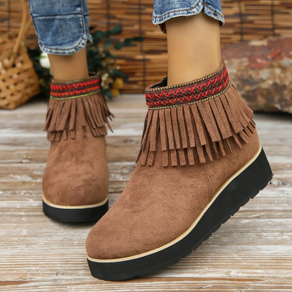 Women's black suede wedge ankle boots with side zip, tassel, and thick rubber sole.