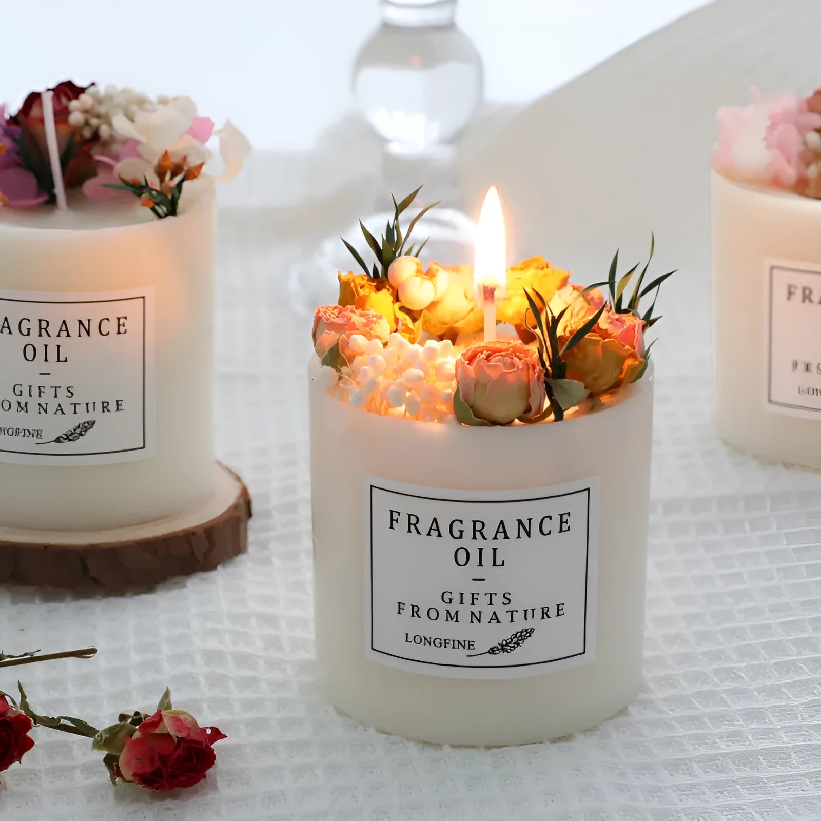 Glass jar scented candle with dried flower decoration, available in multiple fragrance options
