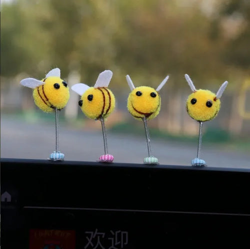 Small yellow and black fur ball bee car decoration ornament measuring 3cm.