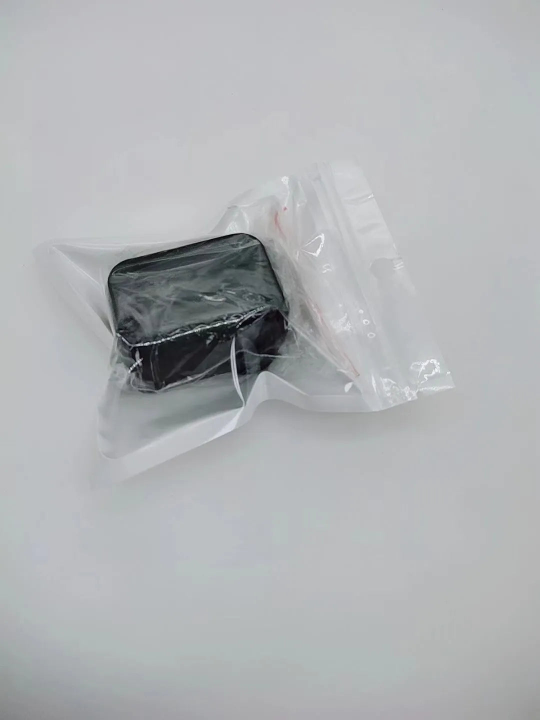 Black ABS plastic seat belt buckle clamp holder securing vehicle seat belt latch