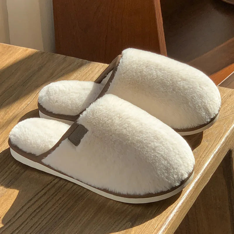 Solid colour PVC plush slippers with non-slip sole and car stitching detail on a wooden floor.