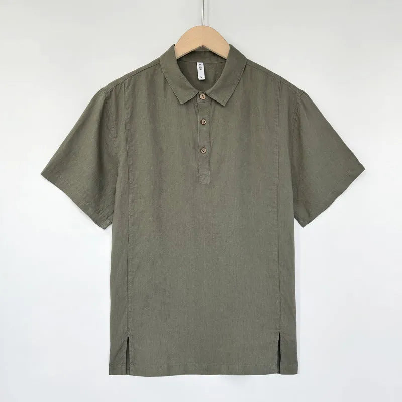 Men's loose grey green linen summer top with thin lapel collar and short sleeves laid flat.