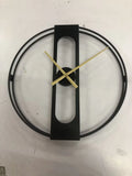 Large 50cm round metal wall clock in black or gold finish on a wall