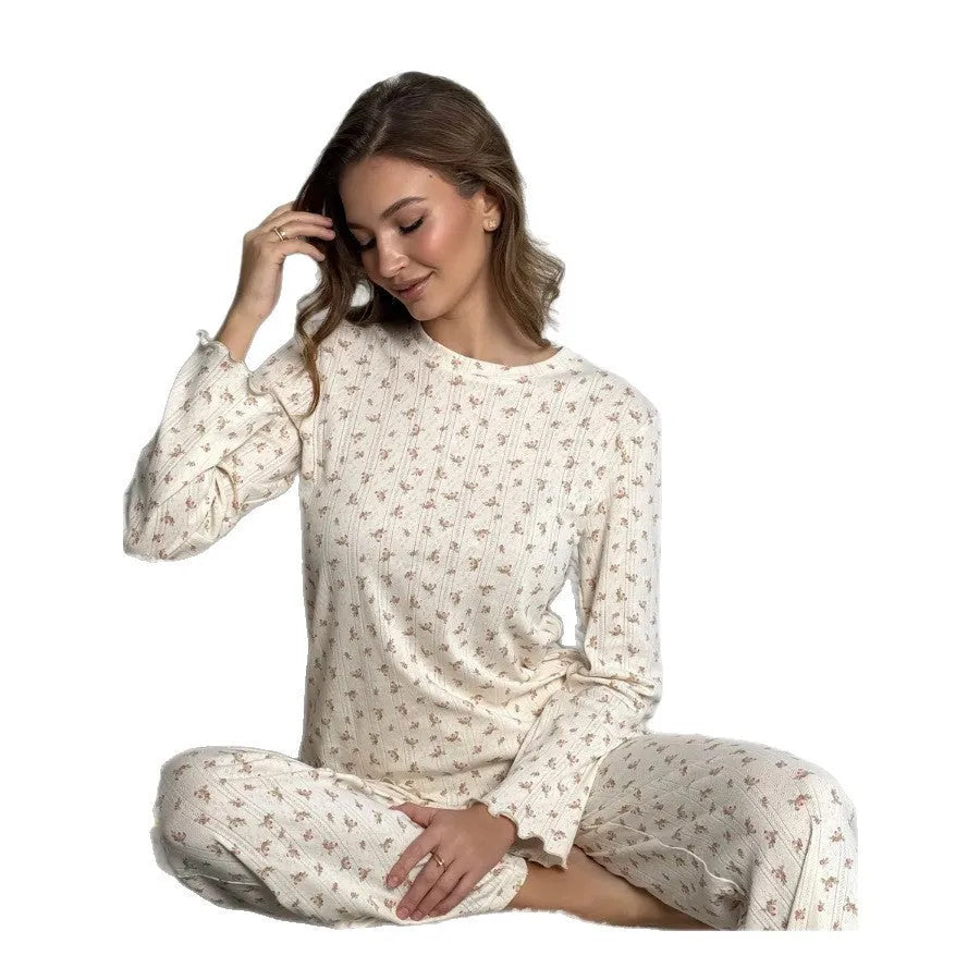 White women's floral print bell sleeve top and wide leg pants casual suit set laid flat