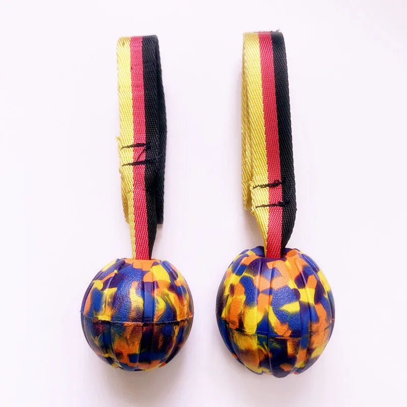 Floating camouflage and yellow EVA pet training ball with knotted tether in three diameter sizes for water retrieval