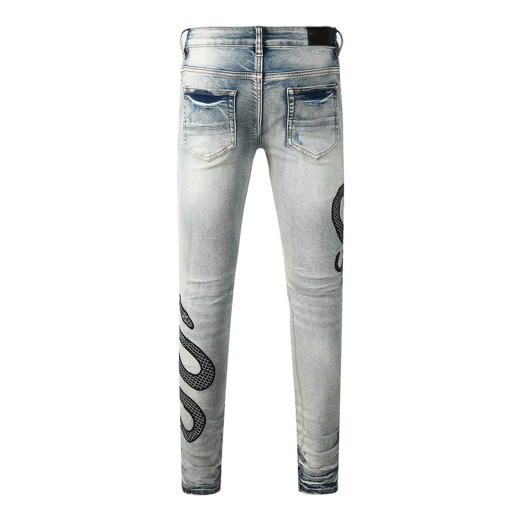 Men's blue distressed skinny jeans with a retro wash, showing a tight leg fit and button fly detail.