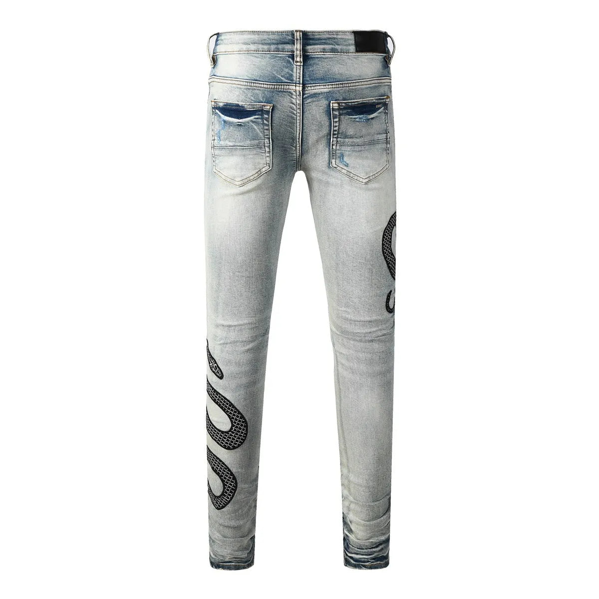 Men's blue distressed skinny jeans with a retro wash, showing a tight leg fit and button fly detail.