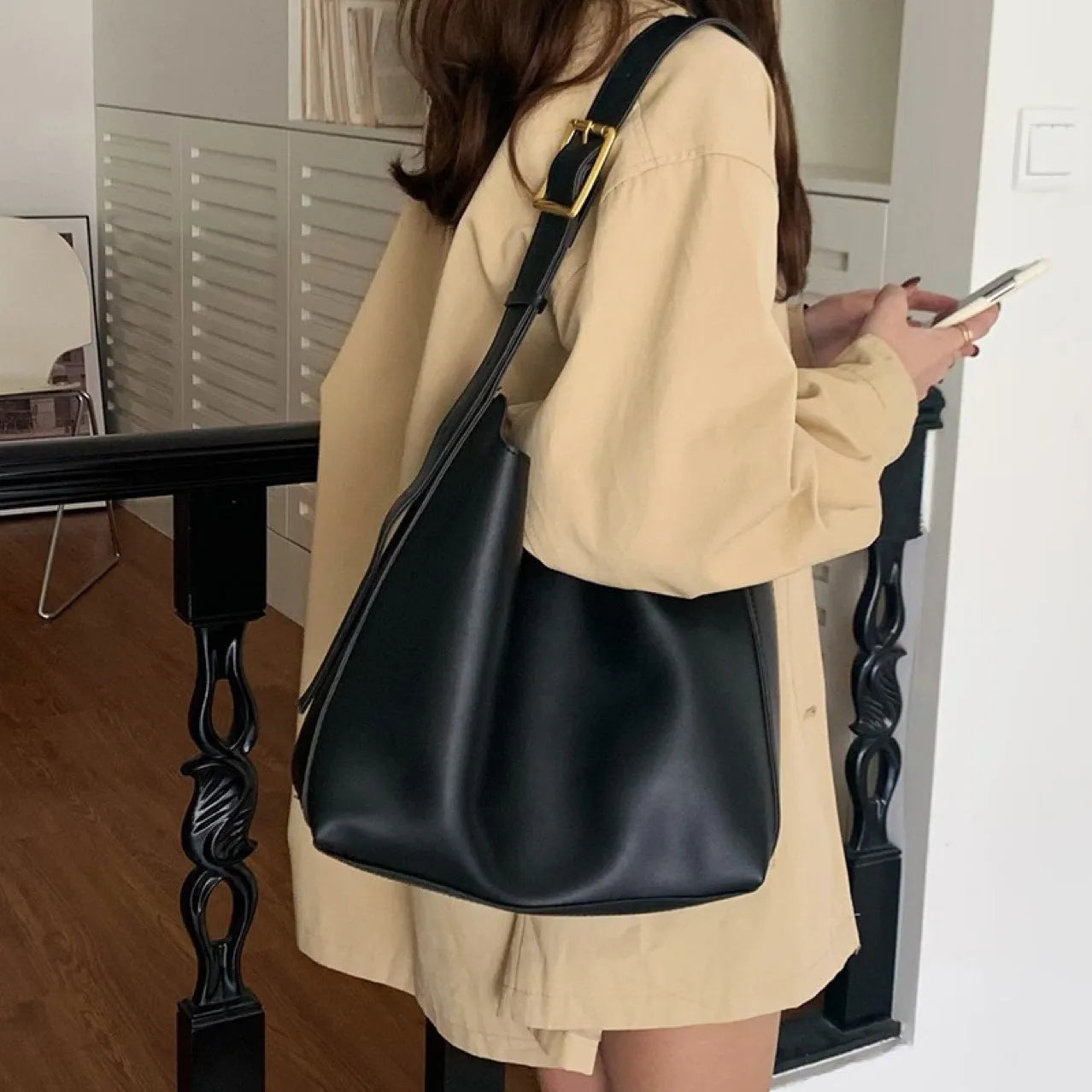 Two women's soft PU shoulder bags with swing threads, one black and one brown, showing structured design.