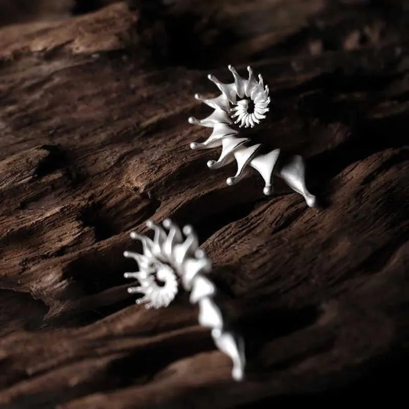 Conch ear studs with exaggerated three-dimensional matte finish and irregular geometric shape