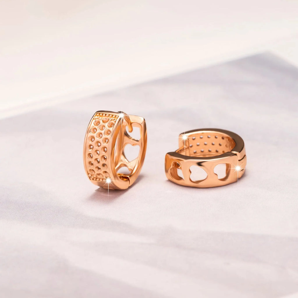 Rose gold electroplated women's earrings with three hollow heart designs in circular frame