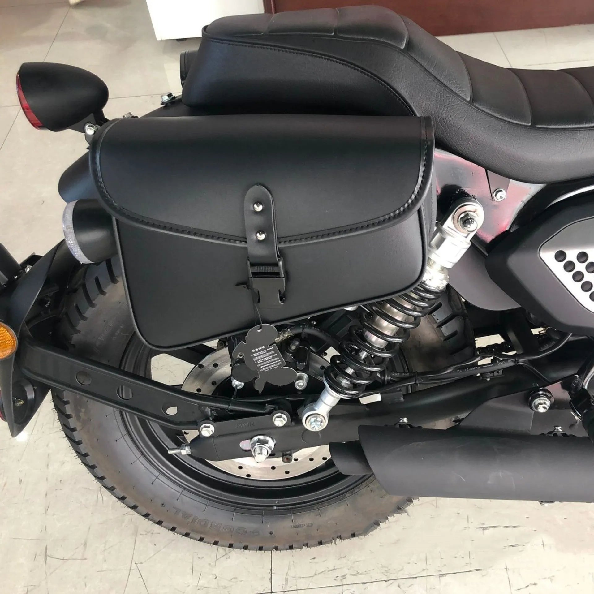 Black PU leather motorcycle swingarm saddlebag mounted on Harley Sportster