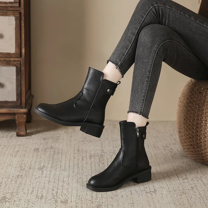 Black women's short boots with a low round toe and side zip, shown on a white background.