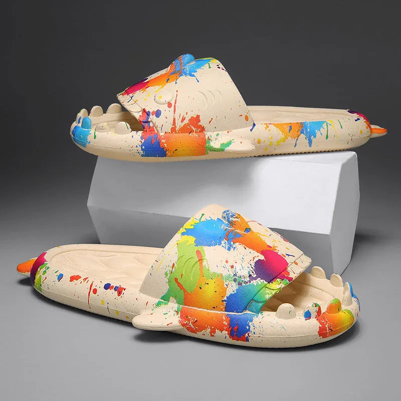 Cute shark design open toe EVA home slippers in assorted colours on a white background.
