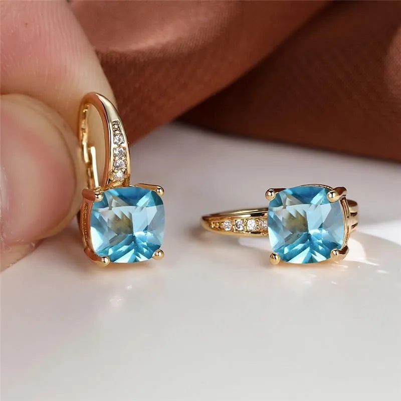 Square geometric ear hook earrings with zircon stones in an electroplated copper setting.