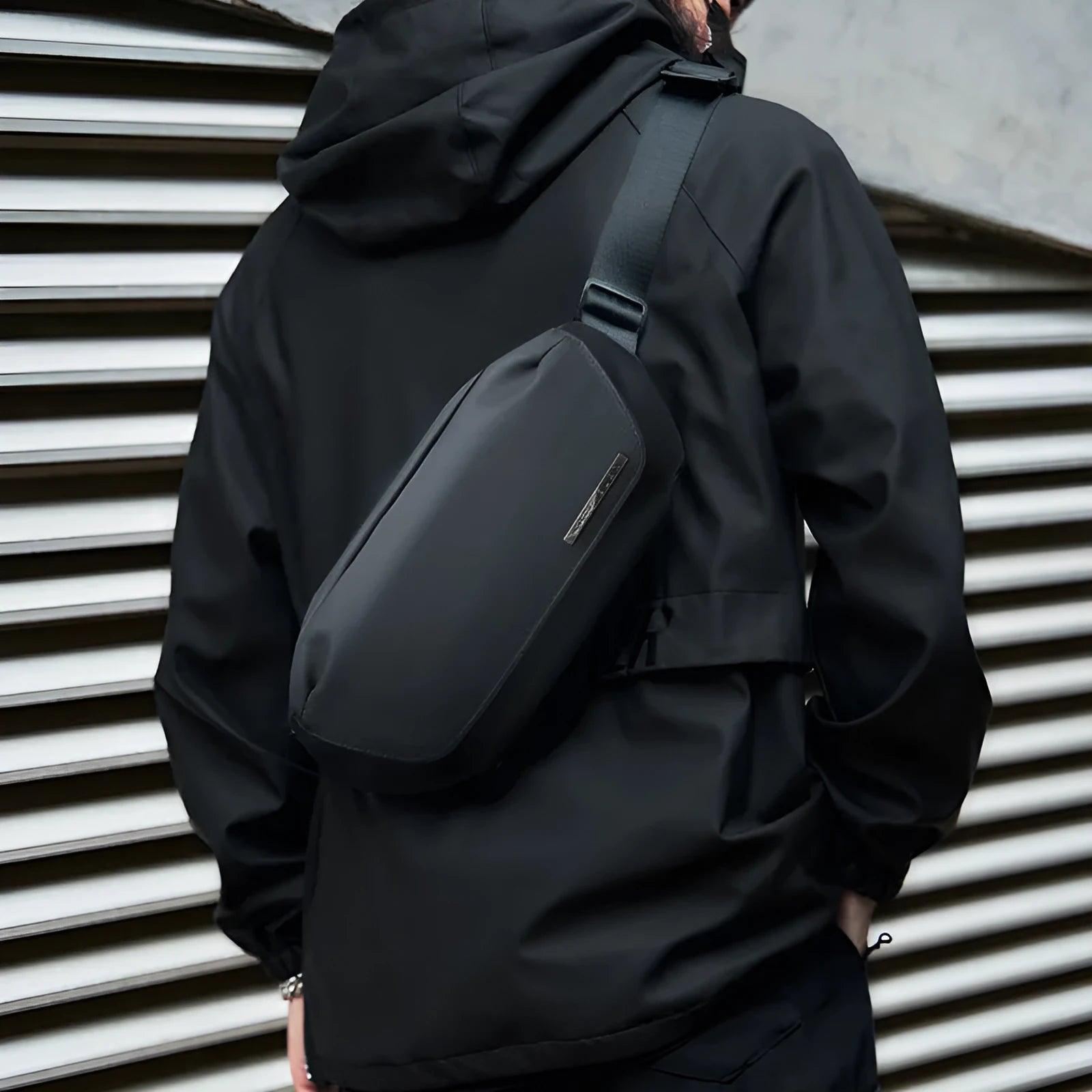 Black oxford cloth men's messenger bag with a cross-body strap.
