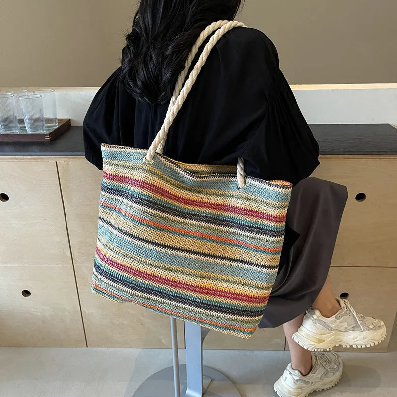 Blue straw woven nylon shoulder bag with single strap and woven texture pattern